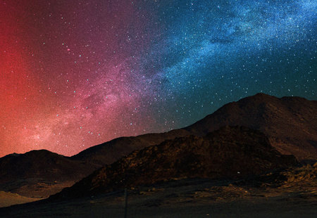 Milky Way over the mountains at night with stars in the skyの写真素材