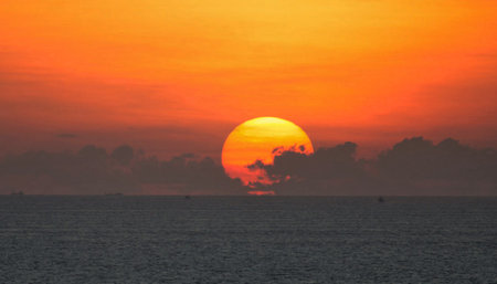Sunset over the sea with a ship in the background, Thailandの写真素材