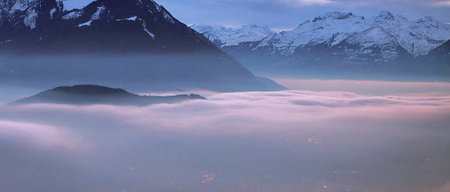 Panoramic view of the mountains in the fog at dawn.の写真素材