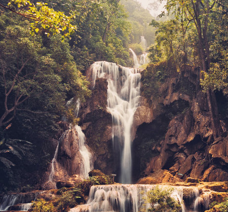 Beautiful waterfall in deep forest, Thailand. Vintage style toned pictureの写真素材