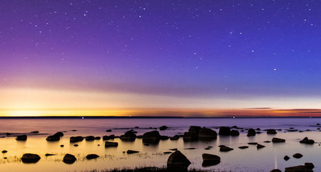 Beautiful starry sky over the sea at sunset. Long exposureの写真素材