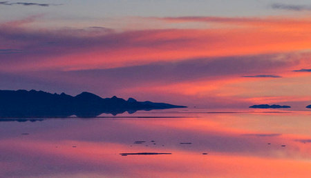 Sunset over the sea and mountains in the background. Colorful sky.の写真素材