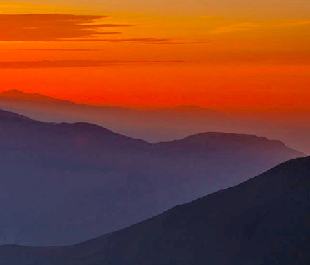 Sunset over the mountains. Vector illustration. Can be used as a background.