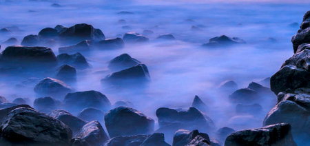 Long exposure shot of rocks in the sea at sunset. Long exposure shot.の写真素材