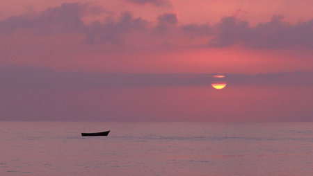 Fishing boat in the sea at sunset. Beautiful sunset over the sea.の写真素材