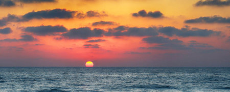 Sunset over the sea. Panoramic view of the sunset over the sea.の写真素材