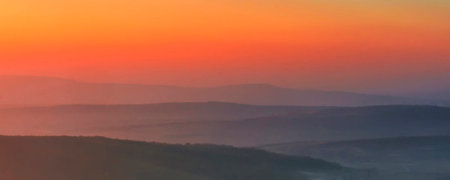 Foggy sunrise in the mountains. Panoramic view.の写真素材