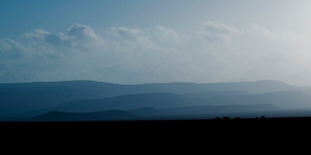 Silhouette of the mountains in the early morning in the desertの写真素材