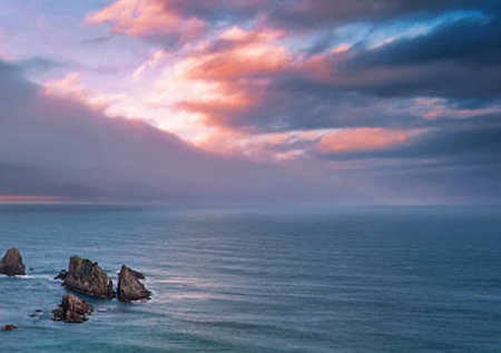 Sunset at the coast on a cloudy day