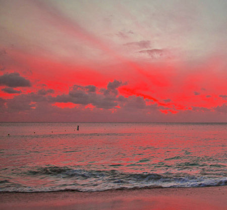 Beautiful sunset over the sea. Red sky and blue sea.