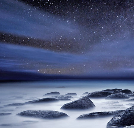 A long exposure photograph of a long exposure photograph of a rocky beach under a starry sky