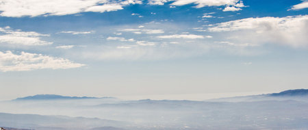 Panoramic view of the mountains and clouds in the blue sky