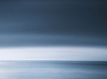 Long exposure seascape with dark blue sky and sea in backgroundの写真素材