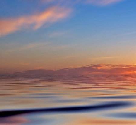 Beautiful sunset over the sea. The sky reflected in the water.の写真素材