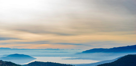 Panoramic view of the sea of fog and mountains in the morningの写真素材