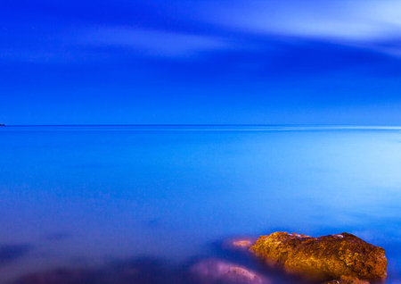 Blue sky reflected in calm sea water. Beautiful seascape.の写真素材
