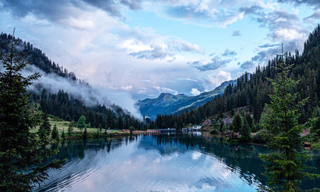Mountain lake in the mountains at sunset. The concept of active and photo tourism