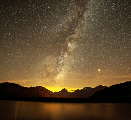 Milky Way over the lake in the mountains with starry sky