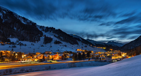 Swiss alps in the winter at night with snow covered houses