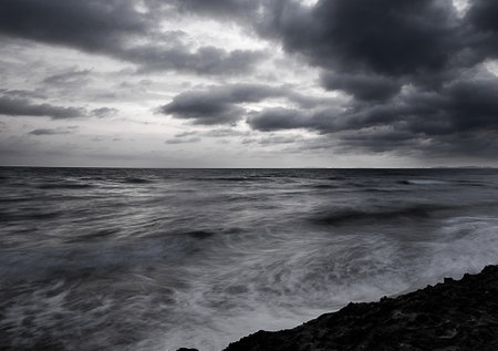 Stormy sky over the sea. Black and white photo. Long exposure.の写真素材