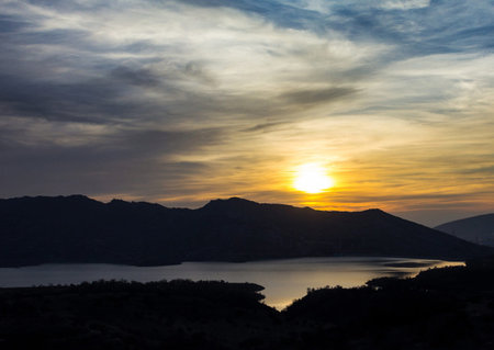 Sunset over the lake in the mountains of Crete, Greeceの写真素材