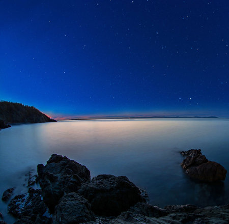 Beautiful night landscape with starry sky over the sea. Long exposureの写真素材