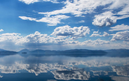 Blue sky and clouds reflected in the water of Lake Baikalの写真素材