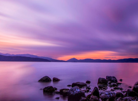 Beautiful sunset at the lake in the evening. Long exposure.