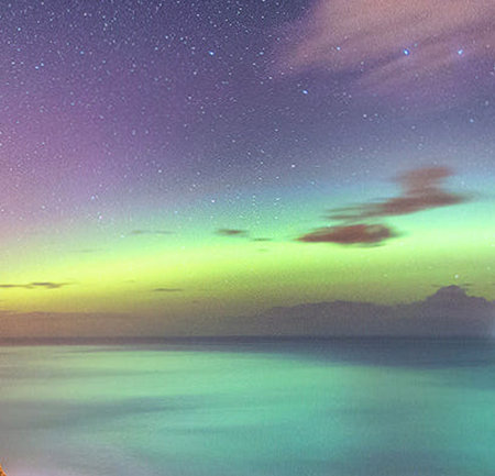 Colorful night sky with stars over the sea. Digital painting.の写真素材