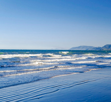 Beautiful seascape with blue sky and waves on the beachの写真素材