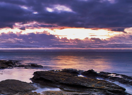 Beautiful sunset over the sea. Dramatic sky over the sea.