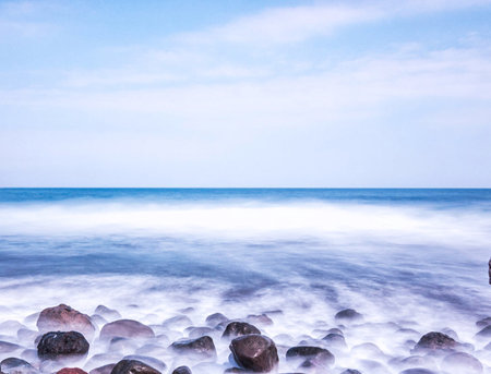 Beautiful seascape with blue sea and rocks on the beachの写真素材