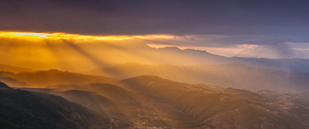 Panoramic view of the mountains and the valley at sunset.の写真素材