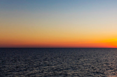 Sunset over the sea. View from the sea to the horizon.の写真素材