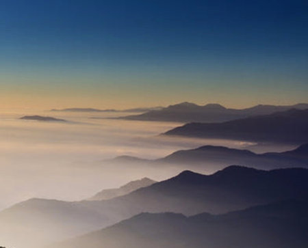 Beautiful landscape of mountain range covered with fog in the morning.
