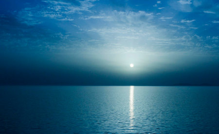 Beautiful sunset on the sea. Blue sky with clouds and sunの写真素材