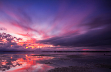 Beautiful sunset on the beach. Colorful sky and cloud.の写真素材