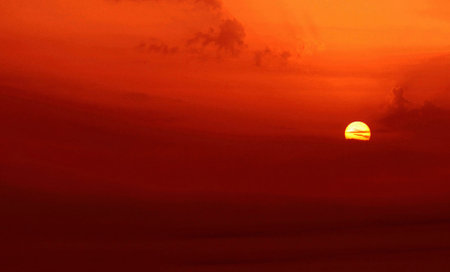 Beautiful sunset on the sky background. Sky with clouds and sunの写真素材