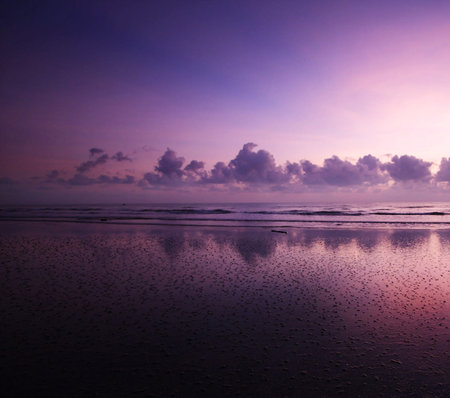 Tropical sunset on the beach with pink and purple colors.