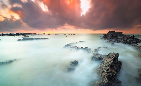 Long exposure seascape at sunset. Long exposure shot of a rocky beach.
