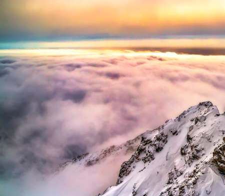 Beautiful winter landscape in the mountains. Sunrise over the clouds.