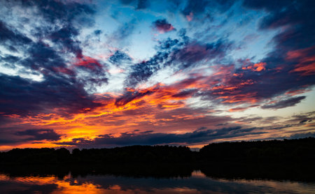 beautiful sunset over the lake with clouds reflected in water, nature seriesの写真素材