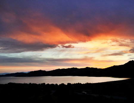 Beautiful sunset over the sea with a view of the mountains.の写真素材