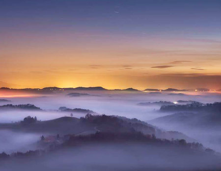 Beautiful sunrise over the mountains with fog in the valley