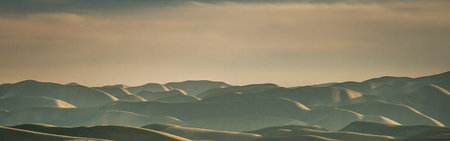 Beautiful panoramic view of sand dunes at sunset.