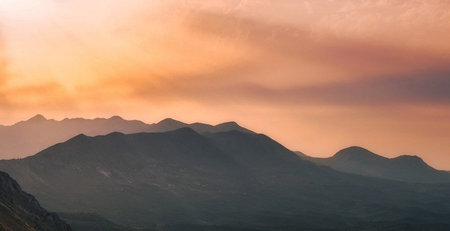 Sunset over the mountains. Panoramic view of the mountains at sunset.の写真素材