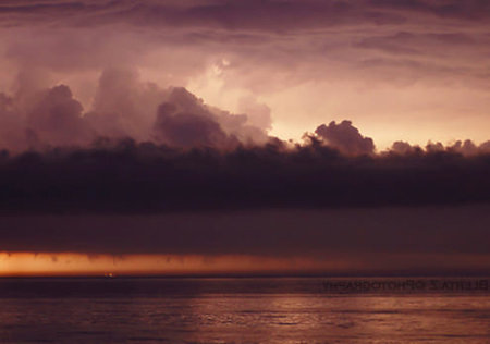 Stormy sunset over the sea. Colorful sky with clouds.
