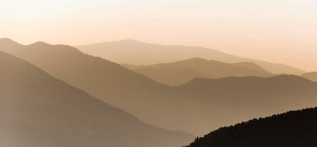 Panoramic view of the mountains in the fog at dawn.の写真素材