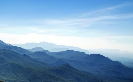 Mountain landscape with blue sky and white clouds. Natural background.