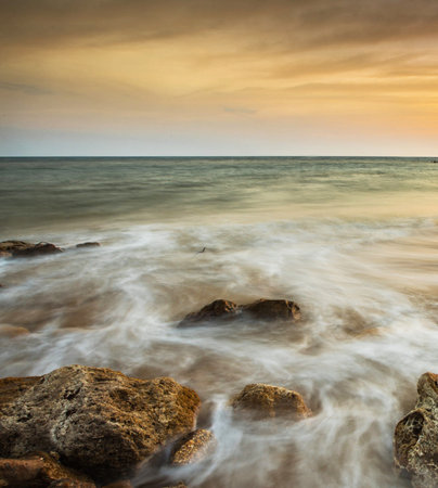 Long exposure of sea and rocks at sunset. Beautiful seascape.